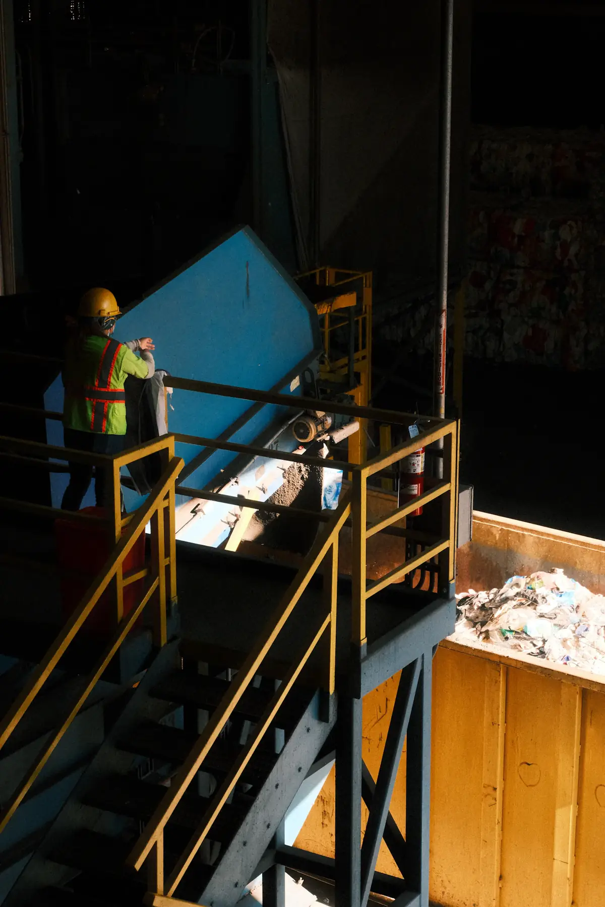 Worker at a recycling facility conveyor